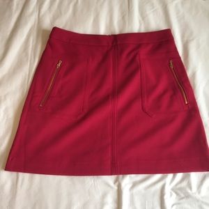 Deep pink skirt with gold zip pockets
